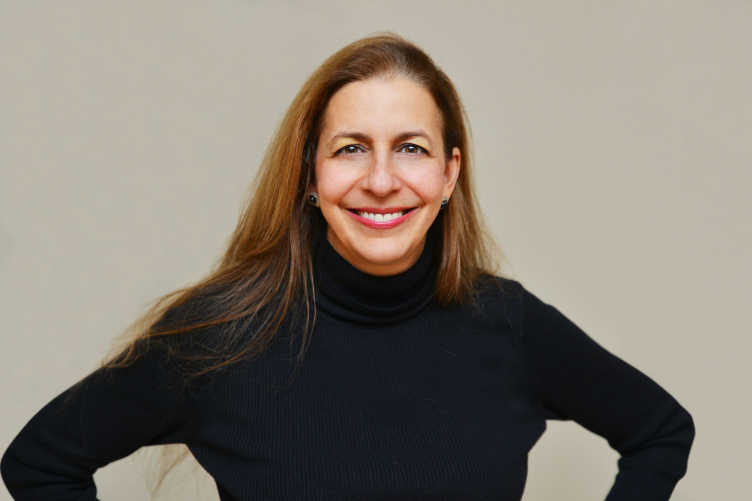 Linda Purpura Fischer in a black turtleneck, smiling